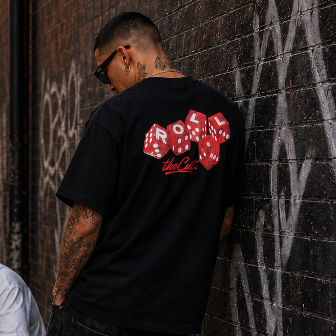 Model wearing theCut Roll One heavyweight tee in black on a city street.