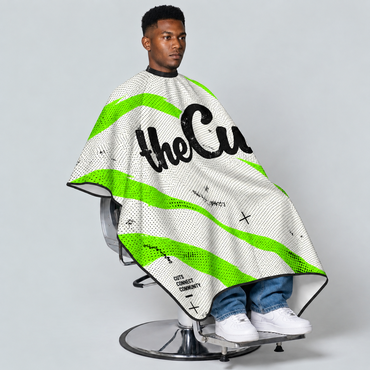 theCut Acid Camo Cape — seated model view on grey background