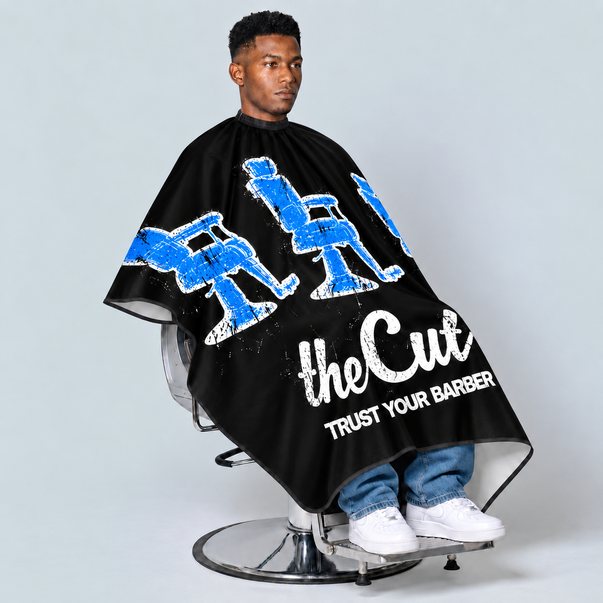 theCut Blue Thrones Cape — seated model view on grey background