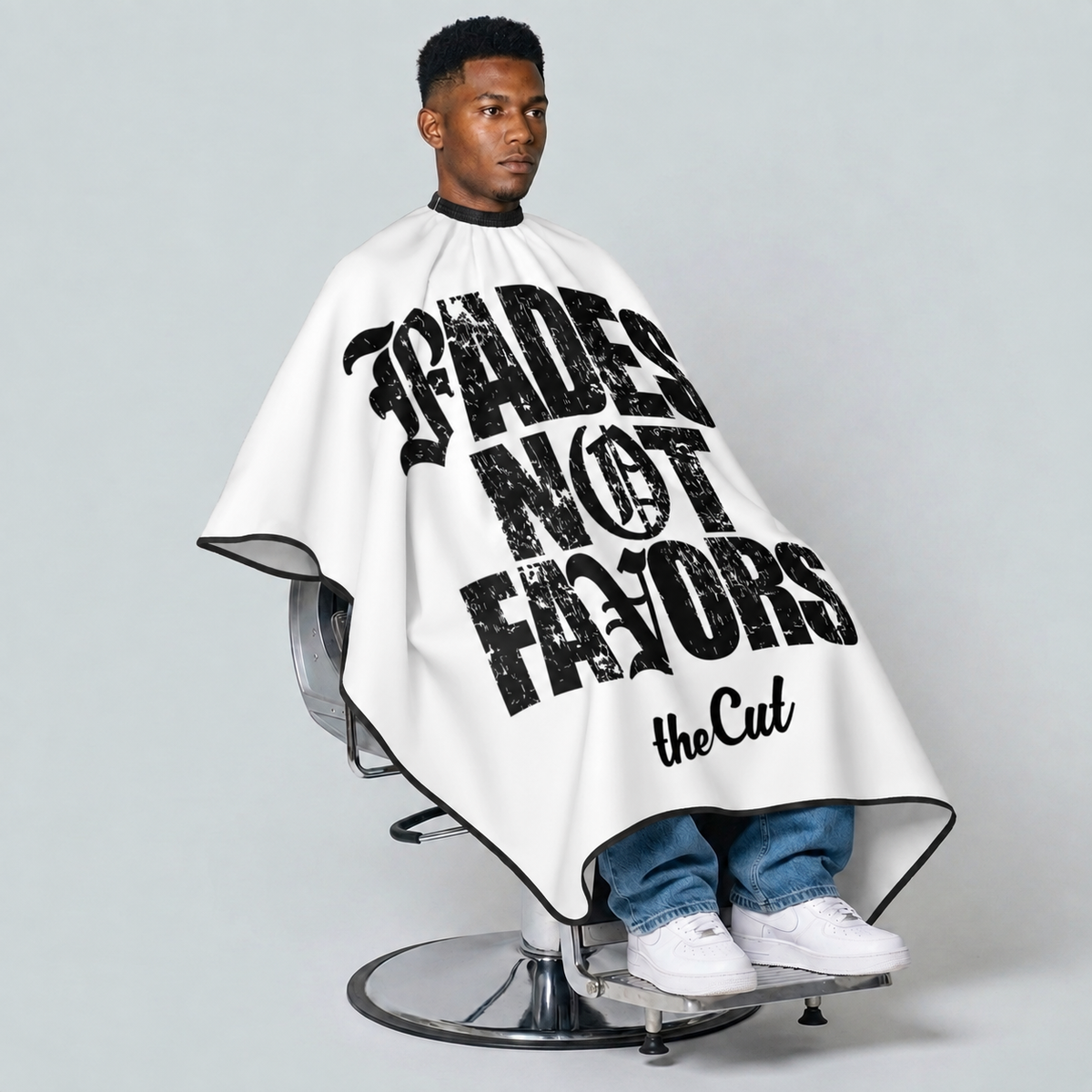 theCut Fades Not Favors Cape — seated view on grey background