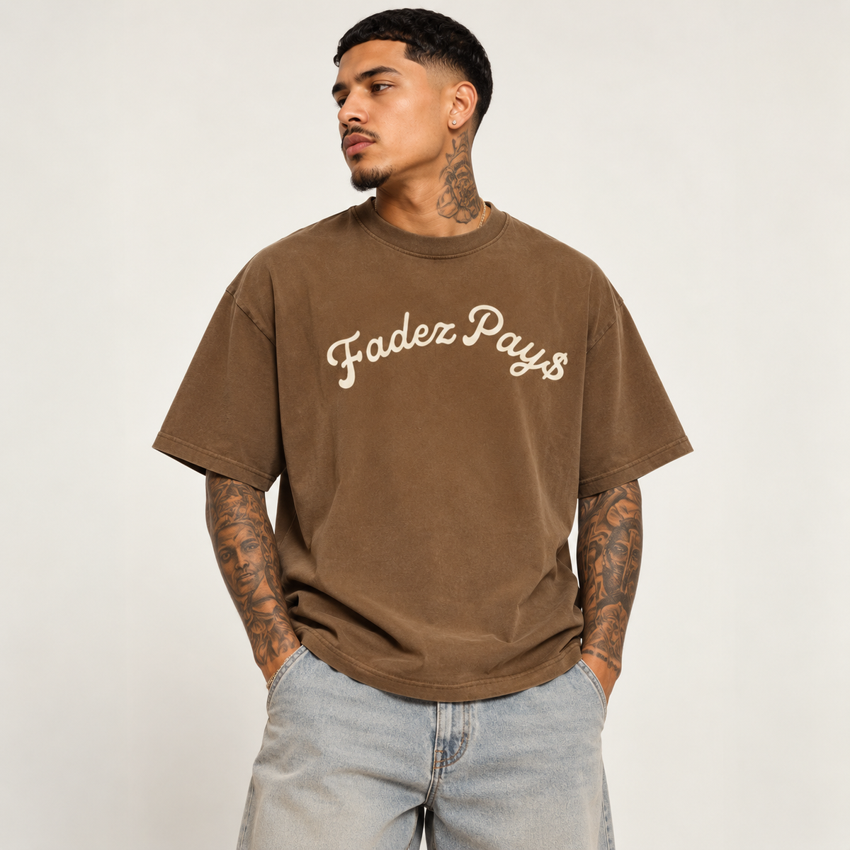 Model wearing theCut FP tee in washed brown, front view, with a cream script logo across the chest.