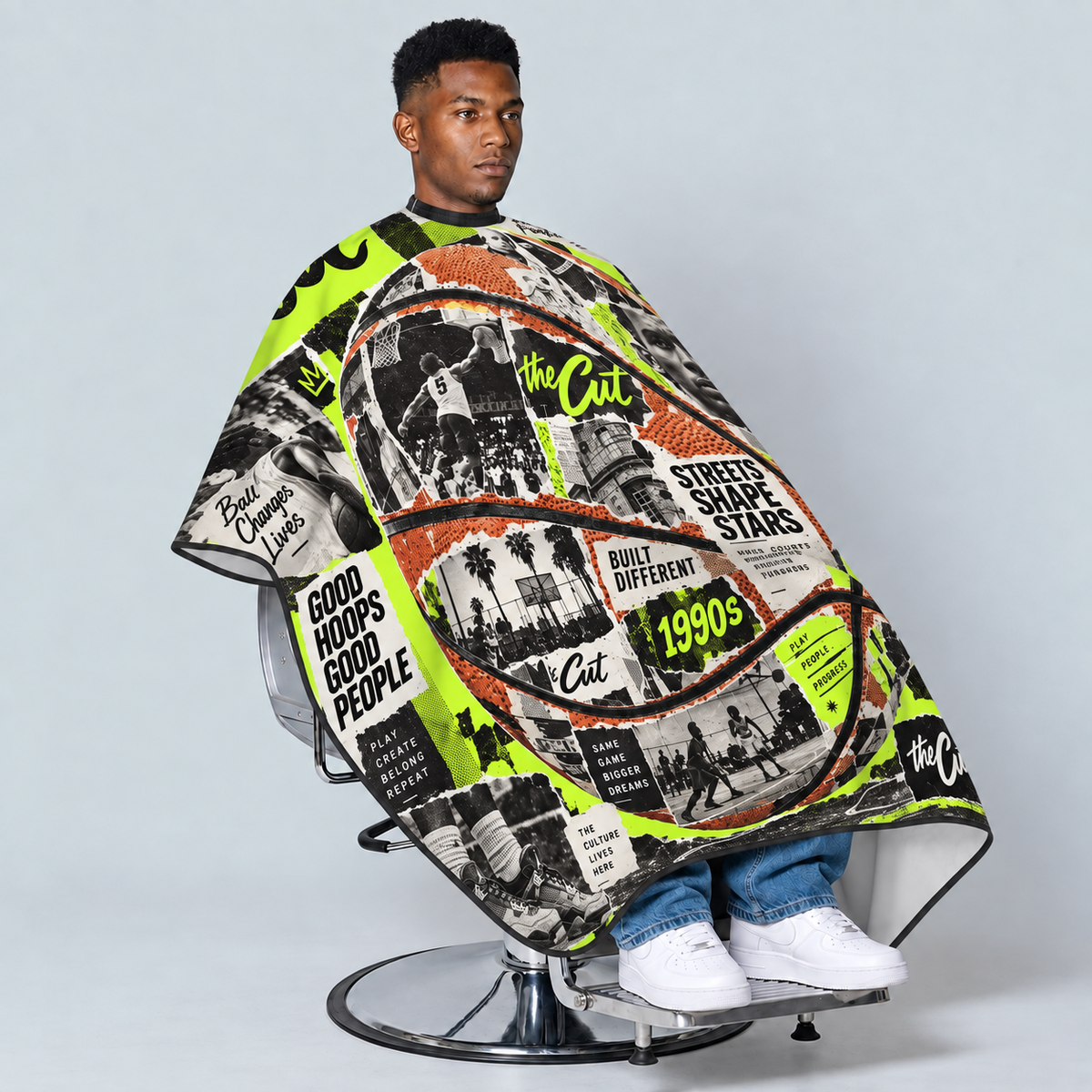 theCut Hardcourt Legends Cape — seated model view on grey background