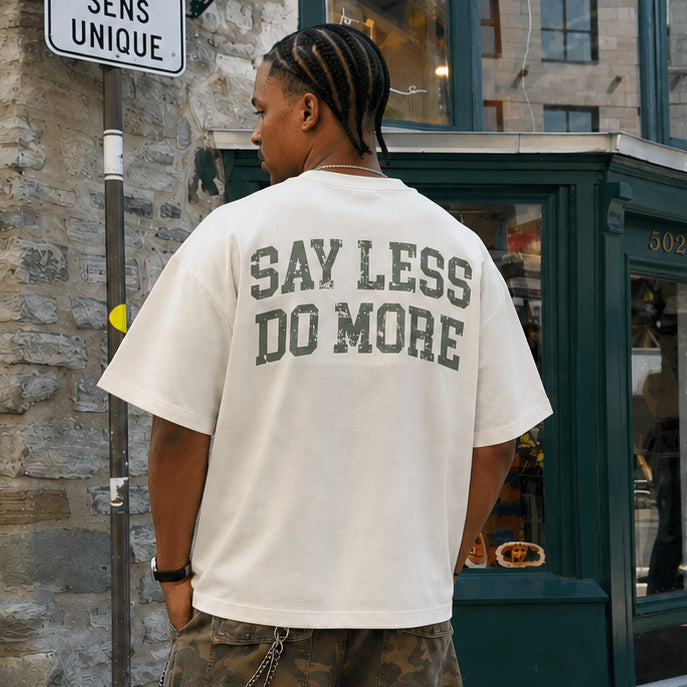 Model wearing theCut Mild Apricot washed boxy cropped graphic tee on a city street.