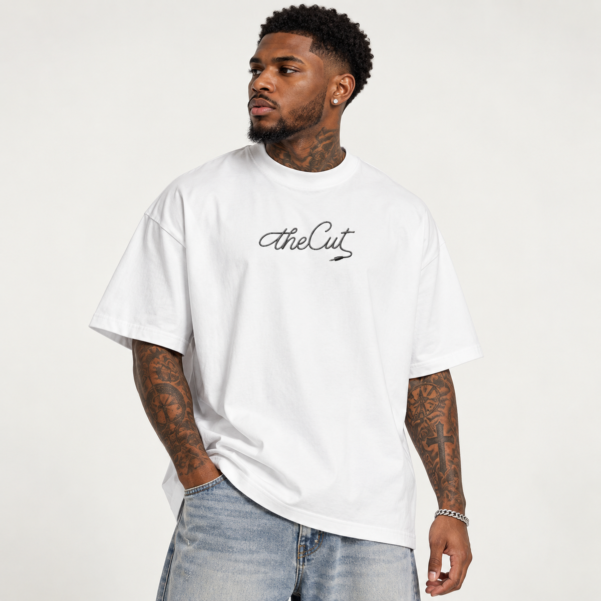 Model wearing theCut Music tee in white, front view, with theCut script logo printed at the chest.