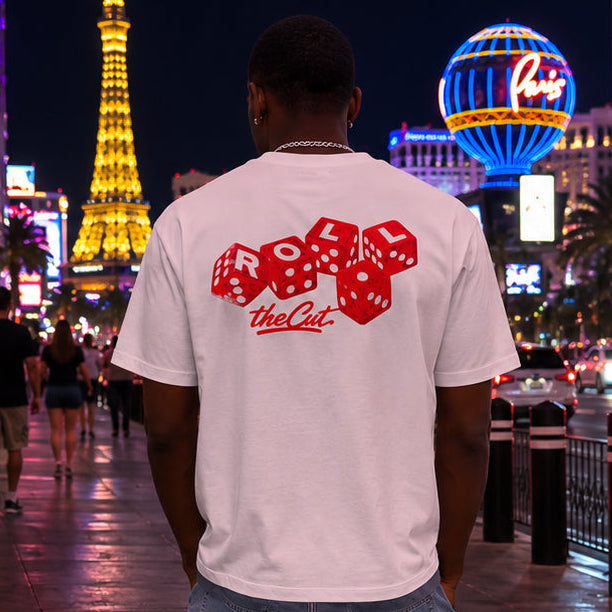 Model wearing theCut Roll One heavyweight tee in white on a city street at night.