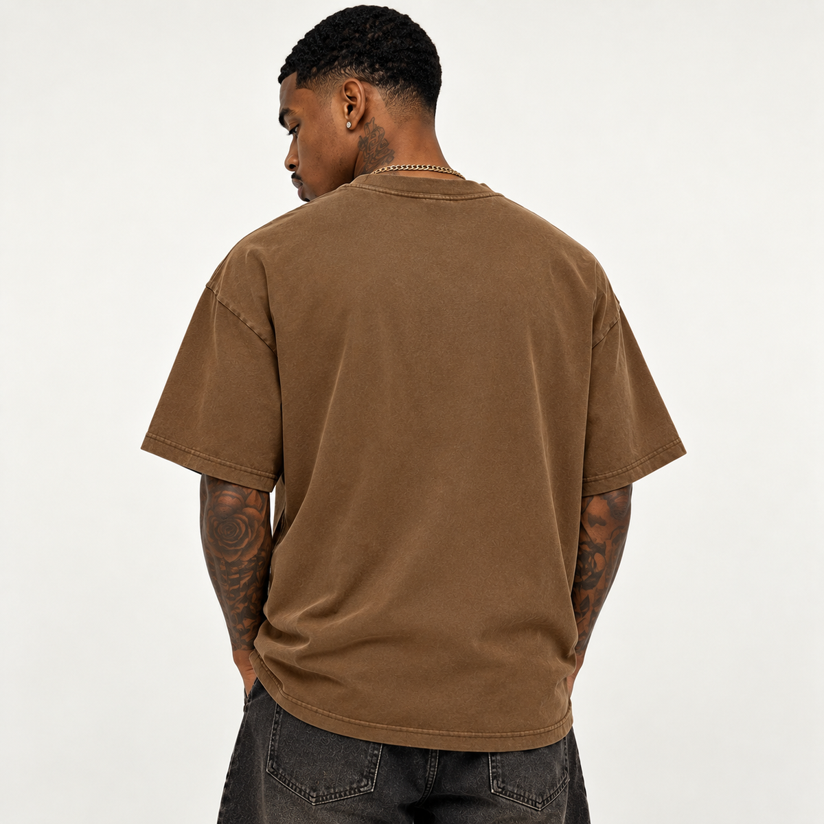 Model seen from behind wearing theCut tee in washed brown, showing the plain back and boxy shoulder fit.