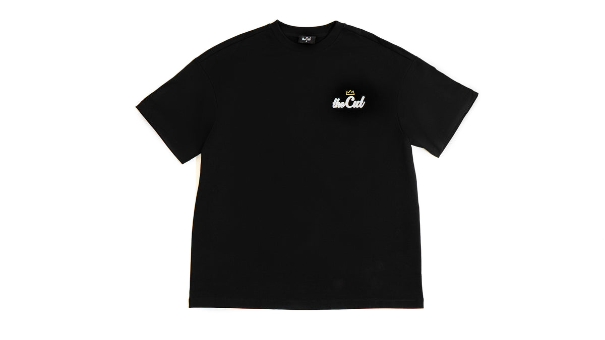 theCut Anywhere tee in black shown flat from the back, with a small chest logo.