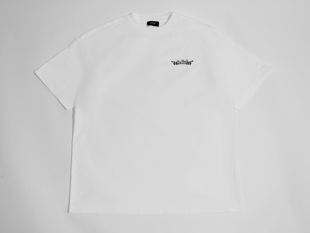 theCut Home Finish tee in white shown flat from the back, with a small chest logo.
