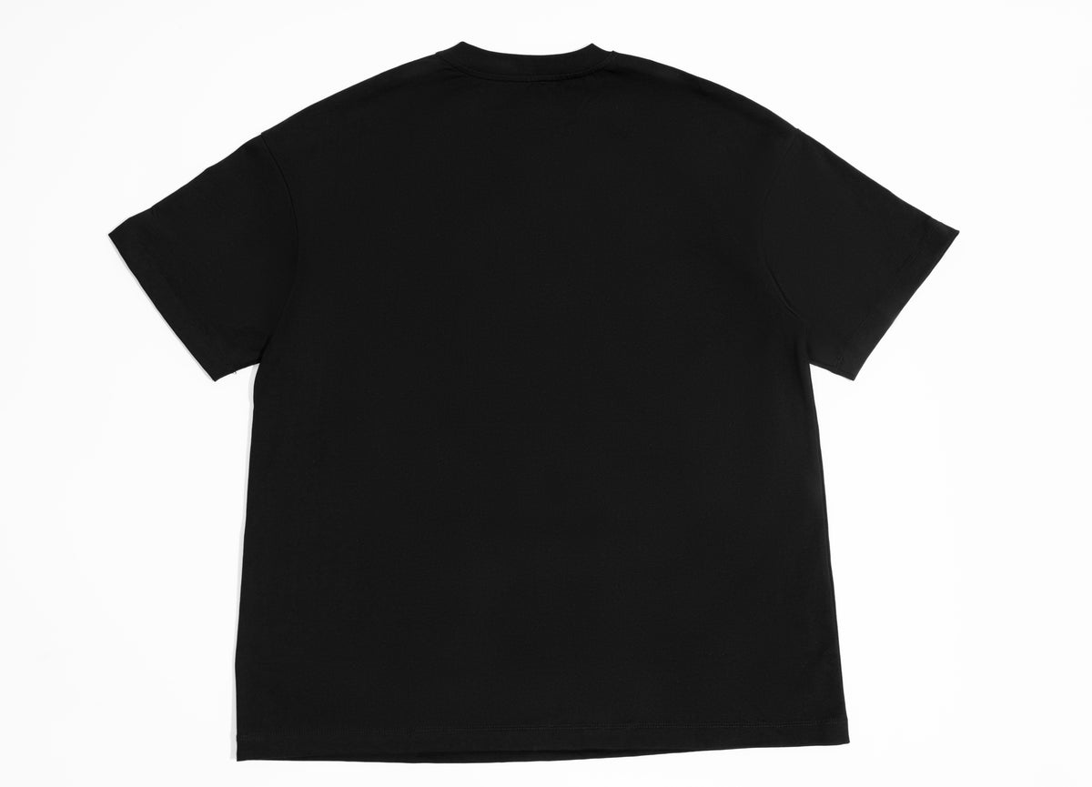 Close detail of theCut Puffed Logo tee in black, showing fabric and stitching.